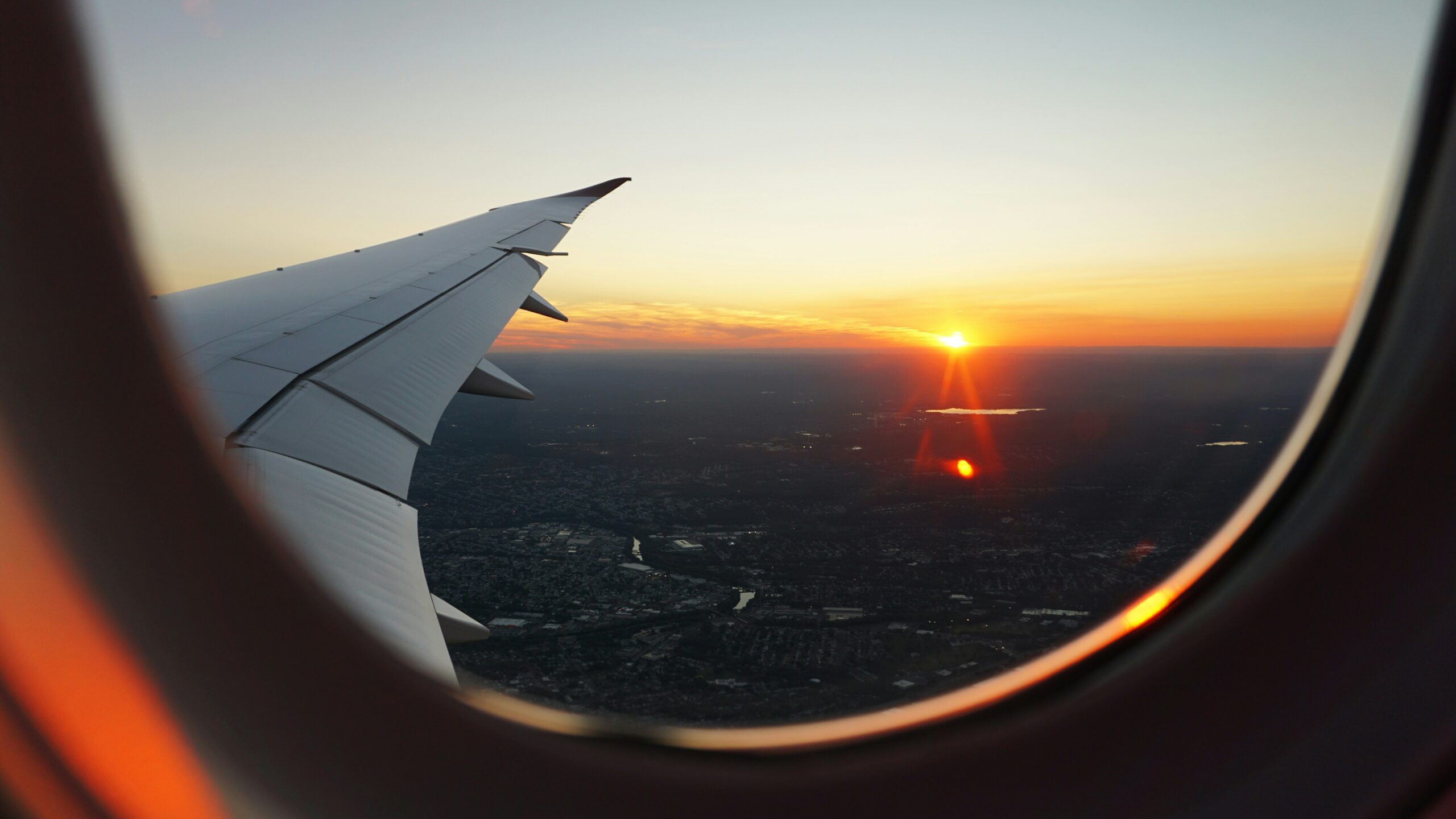 A view of a sunset out of an airplane window