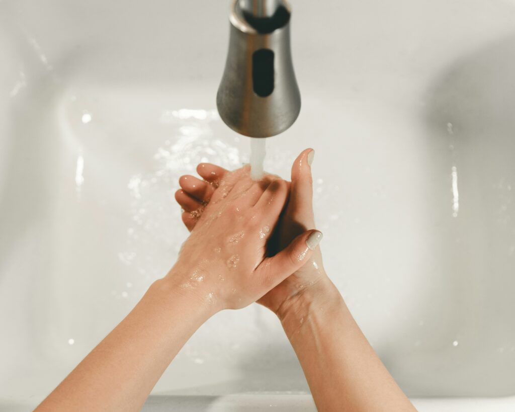 Washing hands in a sink.