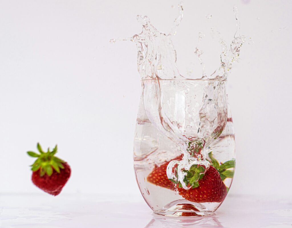 Water with strawberries in it.