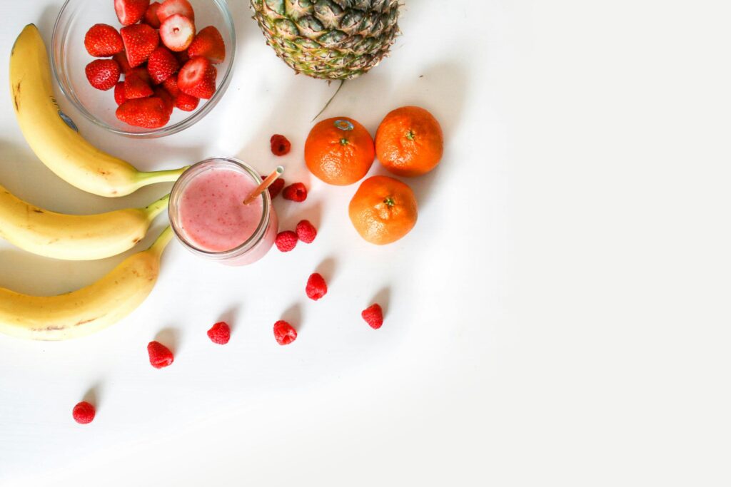 assorted fruit around a smoothie