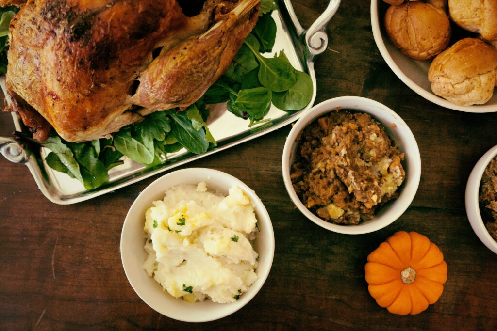 Thanksgiving table with turkey, stuffing, and mashed potatoes