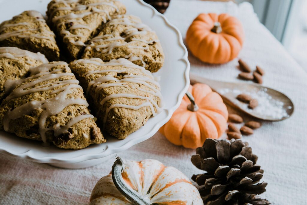 Pumpkin scones with some mini pumpkins and pinecones